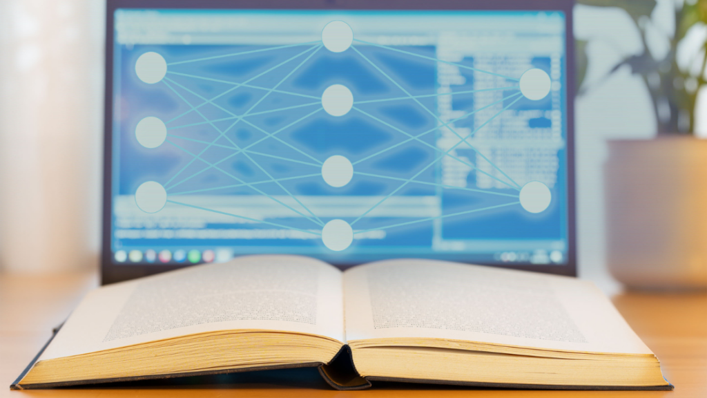 Laptop und Buch mit Anzeichen für Künstliche Intelligenz